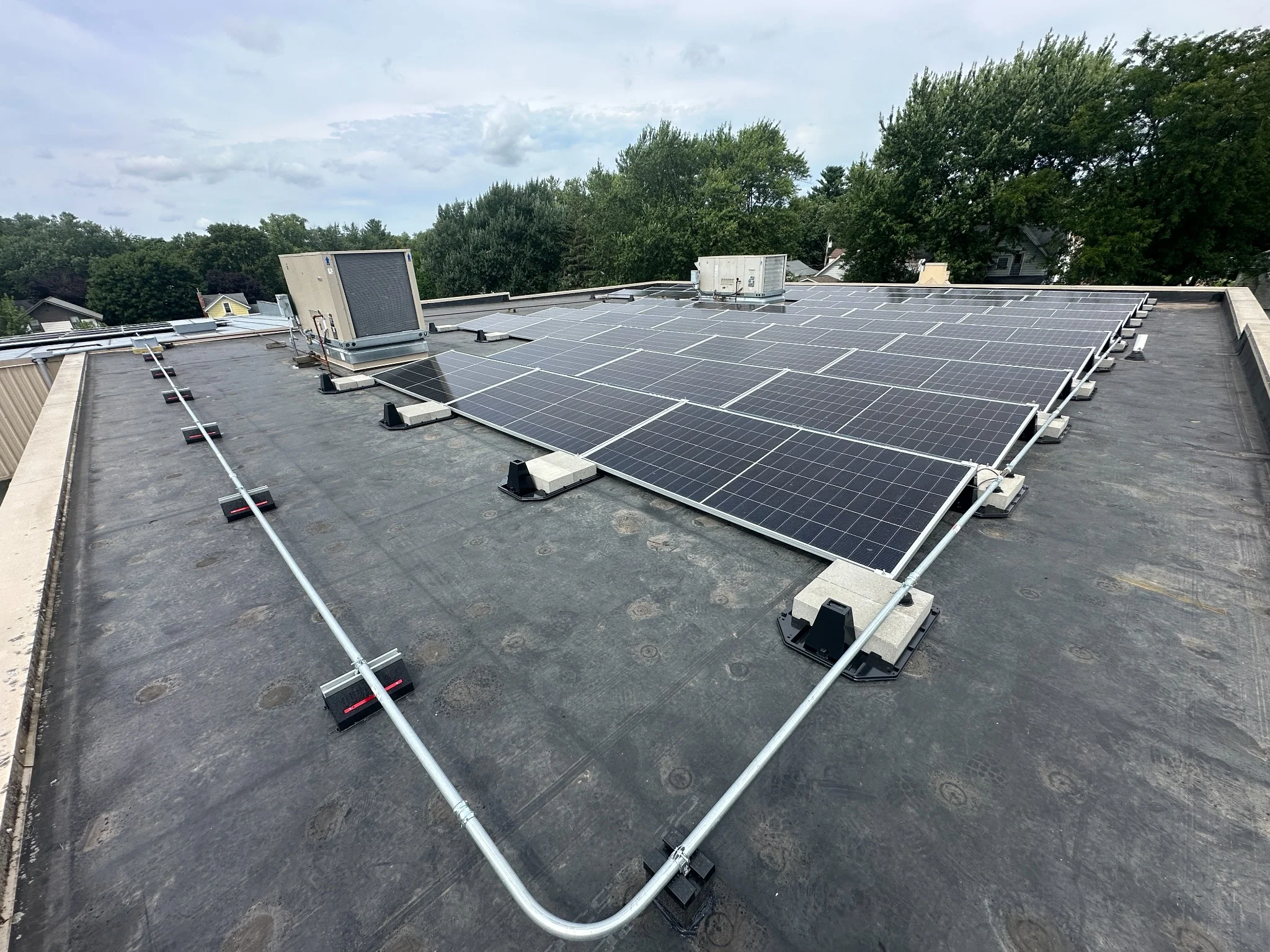 Ballasted solar racking system supporting rooftop solar panels at Trinity Lutheran Church