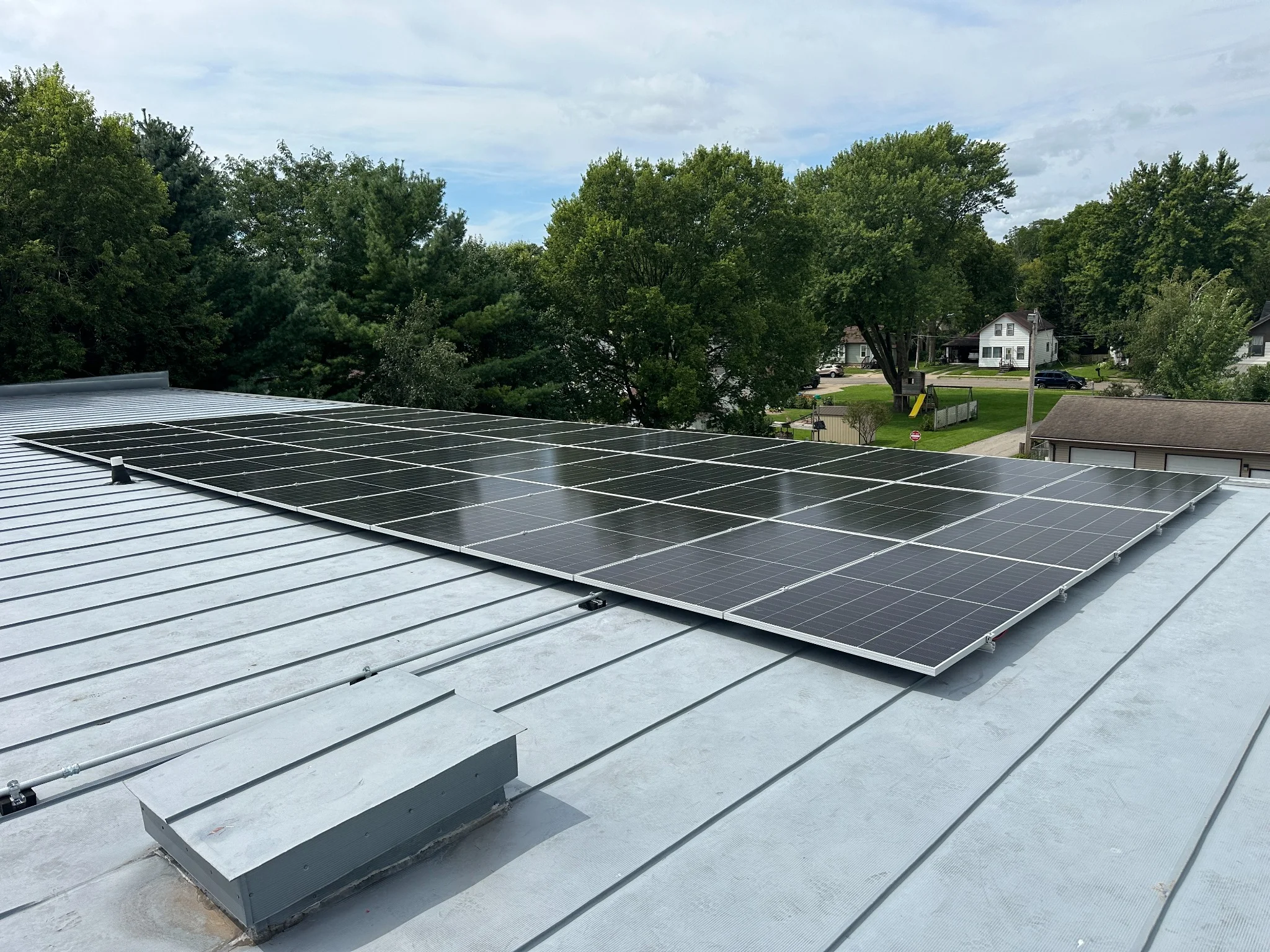 Standing seam metal roof solar array generating clean energy for Trinity Lutheran Church
